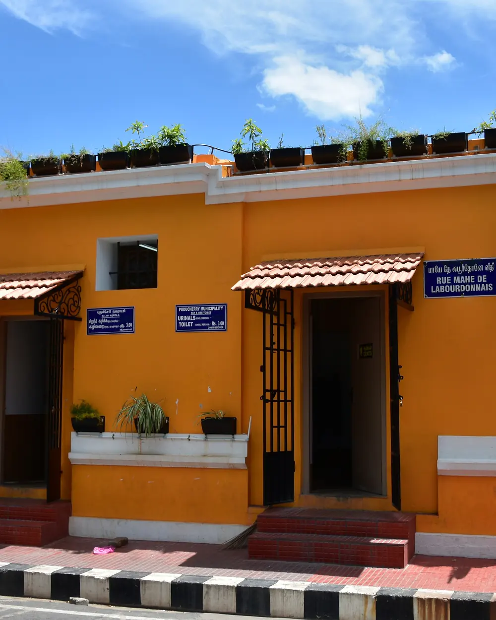 Mustard French-colonial facade on a quiet White Town street