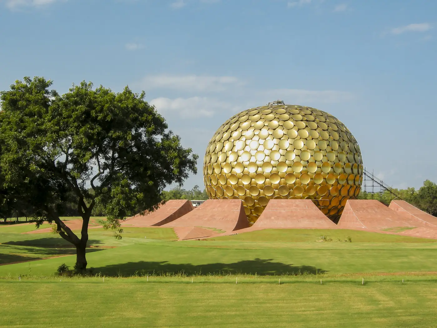 The golden Matrimandir dome on its green lawn at Auroville